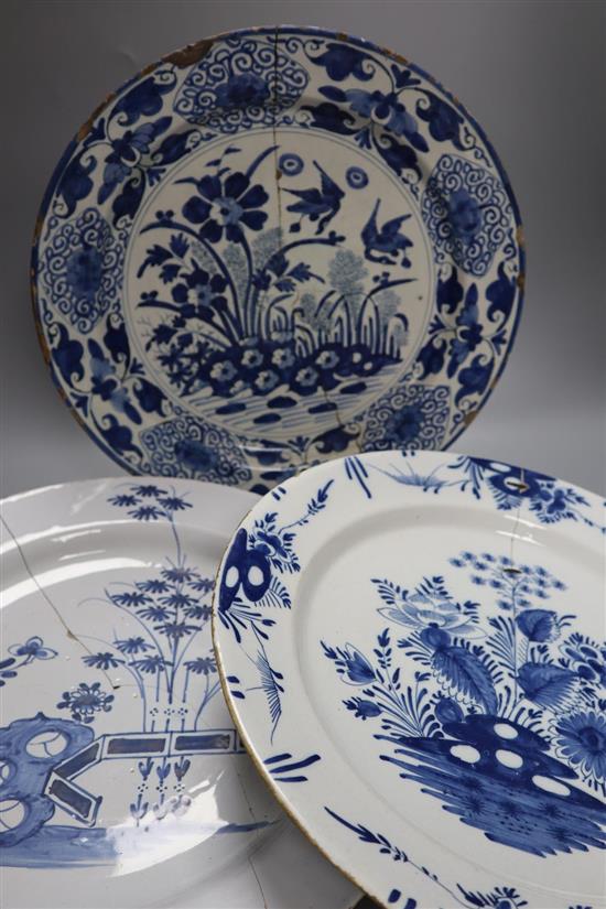 Two 18th century Delft blue and white dishes and a similar English delftware dish, 34-35cm, all a.f.